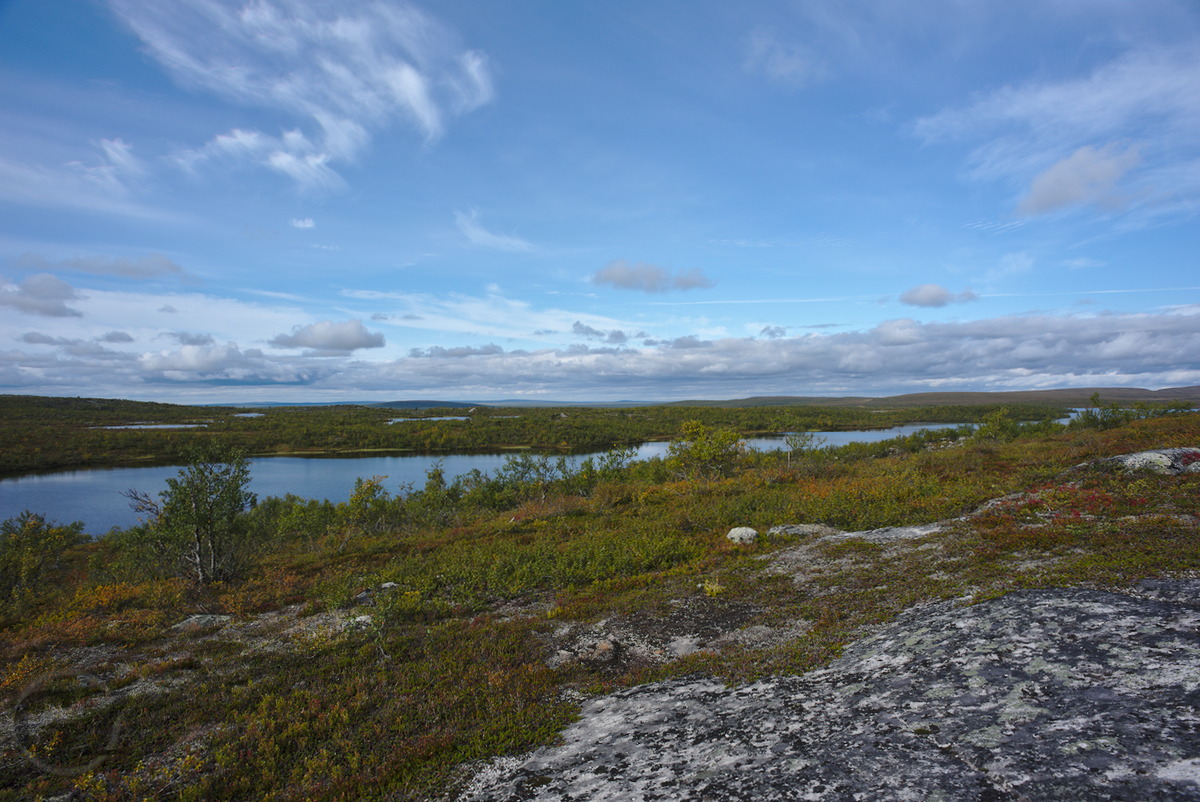 view from a fjell down to long and narrow lake