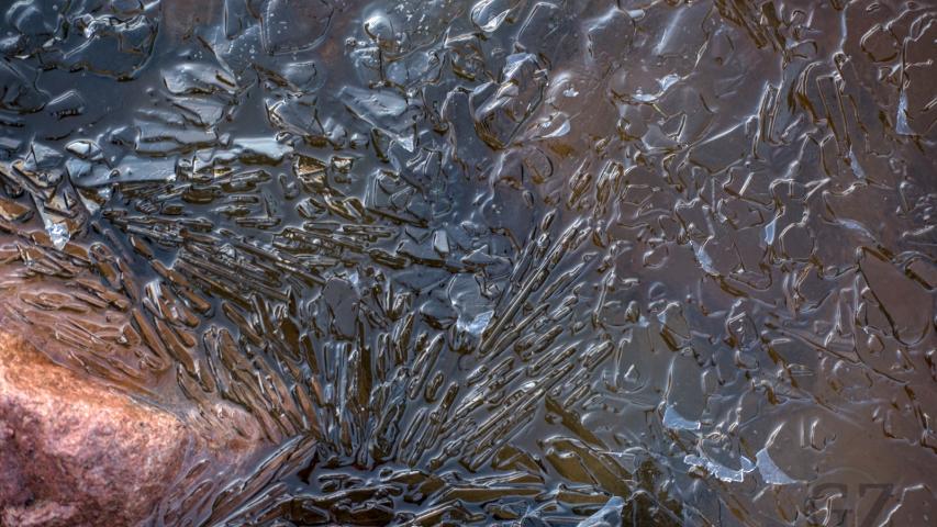 small floating ice pieces near lake shore