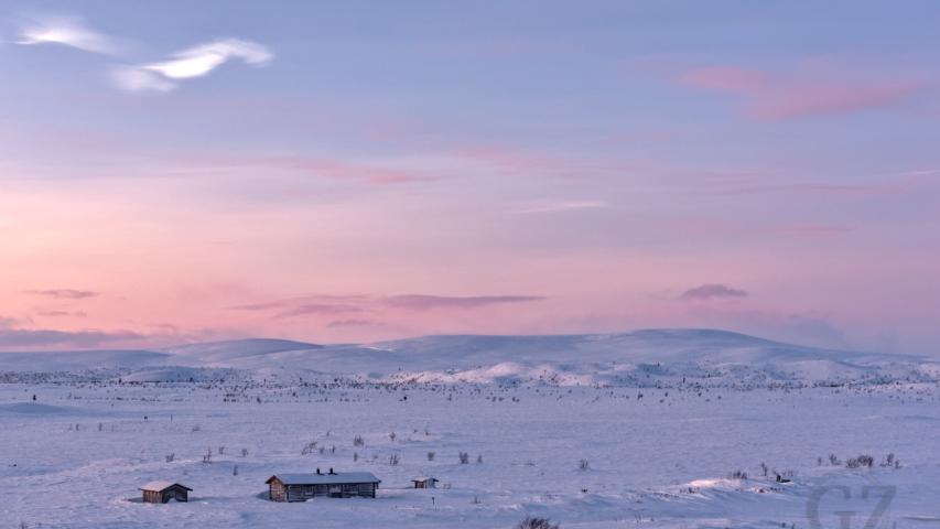 hut in open fell landscape with polar night sky